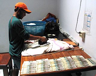 ironing banknotes, Saumlaki, Tanimbars